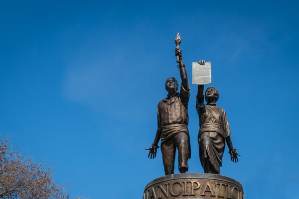 Isolated view of Emancipation statue near the state capitol building set against brilliant blue sky.